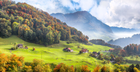 Wall Mural - exciting autumn view on suburb of stansstad city with mountaines and fog