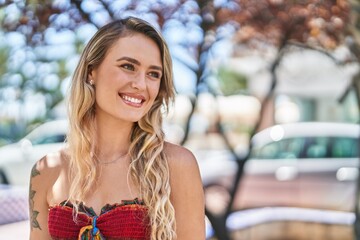 Sticker - Young blonde woman smiling confident looking to the side at park