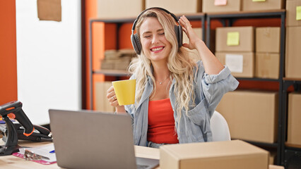 Poster - Young blonde woman ecommerce business worker drinking coffee listening to music and dancing at office