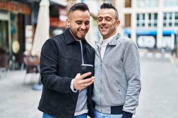 Poster - Two men couple smiling confident using smartphone at coffee shop terrace