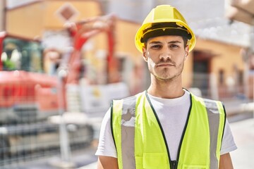 Sticker - Young hispanic man architect standing with relaxed expression at park