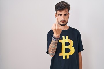 Sticker - Young hispanic man with tattoos wearing bitcoin t shirt showing middle finger, impolite and rude fuck off expression