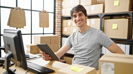 Sticker - Young hispanic man ecommerce business worker using touchpad smiling at office