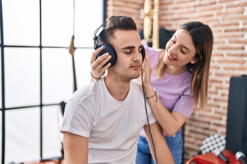 Poster - Man and woman musicians listening to music composing song at music studio