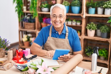 Sticker - Middle age grey-haired man florist smiling confident using touchpad at florist