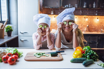 Wall Mural - Mother and daughter cooking