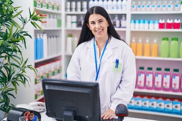 Sticker - Young beautiful hispanic woman pharmacist smiling confident using computer at pharmacy