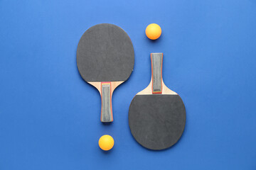Wall Mural - Ping pong rackets and balls on color background