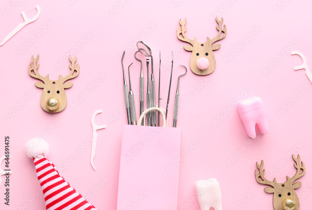 Bag with dental tools and Christmas decor on pink background