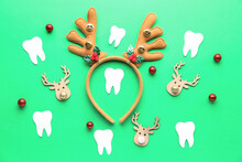 Reindeer Horns With Paper Teeth And Christmas Toys On Green Background