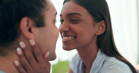 Canvas Print - Love, kissing and young couple at their home relaxing, bonding and resting together on a weekend. Happy, smile and interracial man and woman with intimate romance, connection and trust in apartment.