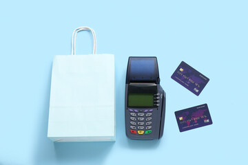 Sticker - Payment terminal with credit cards and shopping bag on blue background