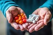 © BOONJUNG - Close up hands showing prescription pills or medical pills or capsules.