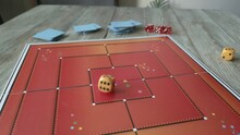Hand Throws Two Yellow Dice On The Playing Field. Gaming Moments In Dynamics. Luck And Excitement. Board Games Strategy