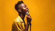 © iwaart - portrait of african american man singing with microphone isolated on yellow background