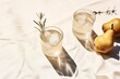 Summer stationery still life scene. Glasses of water, rosemary herb, cut pears fruit and ice cubes. Beige table background in sunlight. Vacation refreshment concept. Long harsh shadows. Generative AI