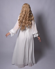 Sticker - Full length portrait of blonde woman  wearing  white historical bridal gown fantasy costume dress. Standing pose, facing backwards walking away from camera, isolated on studio background.