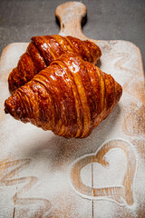 Wall Mural - fresh croissant on the wooden board