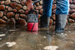 A man pumps out water at the entrance to the garage using a submersible pump.