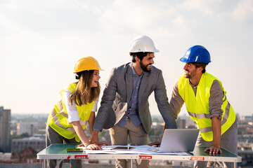 Wall Mural - Business, teamwork and people concept. Group of engineers and architects on construction site