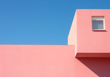Minimal pink building against a blue sky