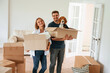 © standret - Dog is in the box. Young couple are moving to new home