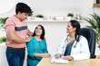 © GAJENDRRA BHATI  - Indian female gynecologist doctor consulting young married couple patients in fertility clinic about IVF or IUI. Planning pregnancy concept.