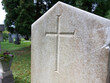 catholic cross on light gray stone at old cemetery in Ptuj. Slovenia