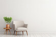 Modern minimalist interior with an armchair on empty white color wall background with copy space