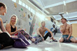 © Flamingo Images - Rock climbing friends sitting on the floor of a gym
