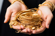 © StockImageFactory - closeup of female hand holding gold jewelry, ornaments - Asset or Gold Loan concept.