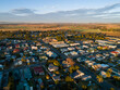 © Austockphoto - Morning sunlight at sunrise on building rooftops in small town