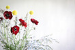 © Austockphoto - Vibrant bunch of flowers on white background featuring Billy Buttons and red Rununculas