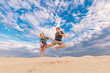 © Austockphoto - Kids jumping for joy on the sand dunes of Stockton Beach at Port Stephens