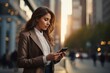 © Premreuthai - Young urban professional businesswoman using smartphone. Businessman holding mobile smartphone using app texting sms message outdoor.
