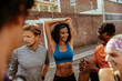 © Marko Geber - Young and diverse group of friends stretching and getting ready to run in the city