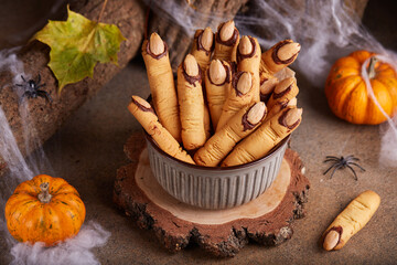 Wall Mural - Halloween cookies witch`s fingers with chocolate and almond nuts. Delicious and scary dessert for treats.