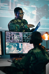 military control room, computer and woman with team leader, headset and tech in communication. secur
