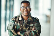 © aLListar/peopleimages.com - Portrait of soldier with smile, confidence and pride at army building, arms crossed and happy professional. Military career, security and courage, black man in camouflage uniform at government agency