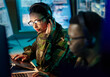 © aLListar/peopleimages.com - Military control room, headset and woman with communication, computer and technology. Security, global surveillance and soldier with teamwork in army office at government cyber data command center.
