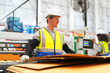 © FotoArtist - Industrial worker indoors in factory. Young technician with orange hard hat. Smart Caucasian factory worker wearing hardhat and working in power plant.