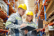 © FotoArtist - Warehouse Industrial supply chain and Logistics Companies inside. Warehouse workers checking the inventory. Products on inventory shelves storage. Worker Doing Inventory in storehouse.