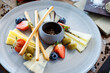 Cheese platter for two: Goat cheese cream, gorgonzola, camembert, grissini and fig jam. Delicious healthy Italian traditional food closeup served for lunch in modern gourmet cuisine restaurant