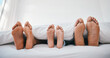 © Wesley/peopleimages.com - Sleeping, feet and family in a bed with love, relax and resting in comfort in their home together. Barefoot, care and child with mom, father and security in bedroom for sleep, bonding and weekend nap