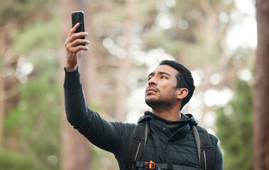 Wall Mural - Phone, connection and man in nature for hiking, trekking and exercise in woods. Fitness, travel and person on smartphone lost with no signal for GPS, online location and digital map on adventure