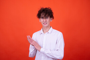 Wall Mural - Study and work. Attractive curly student posing on an orange background.