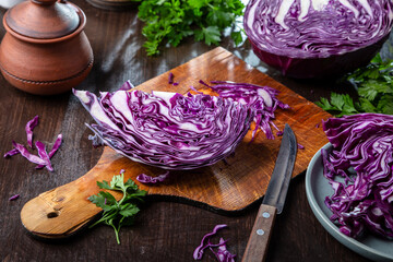 Chopped red cabbage close-up on a cutting wooden board in the kitchen
