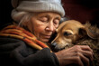 an elderly woman hugs her pet dog with her face pressed to him. Caring for animals. loneliness