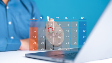 Wall Mural - Officeman or secretary uses a computer to make appointment reminders or meeting agenda on calendar. Schedule time management for time effective work. Agenda events information and meeting organizer.