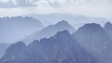 Pano 4K aerial footage of misty early morning High Tatras mountain range with incredible light and shadows play. Rysy peak 2499m view.